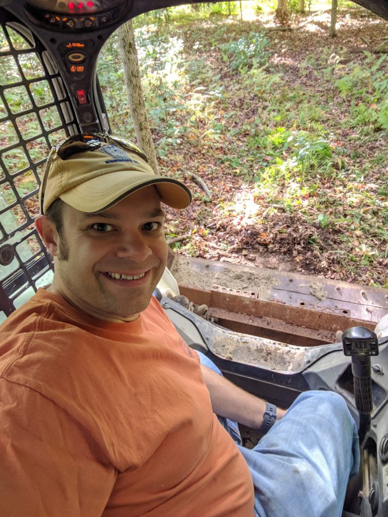 Derek driving the skid steer